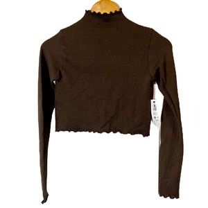 Garage, long sleeve, mock neck, crop top with scalloped hems.